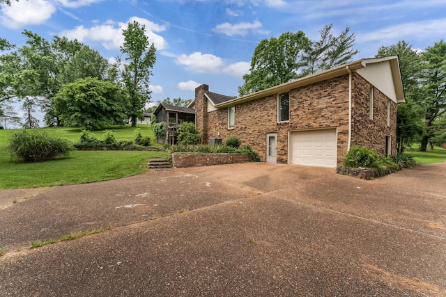 123 Proffitt St, Carthage, TN 37030 - view of front facade with concrete driveway, brick siding, a front yard, a garage, and a chimney