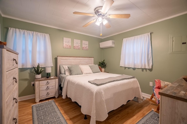 502 N Main St, Loretto, TN 38469 - bedroom featuring a wall mounted AC, ornamental molding, wood finished floors, and ceiling fan