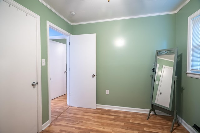 502 N Main St, Loretto, TN 38469 - unfurnished bedroom with ornamental molding, light wood-style flooring, and multiple windows