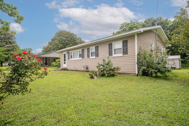 502 N Main St, Loretto, TN 38469 - view of front facade featuring a front yard and a shed