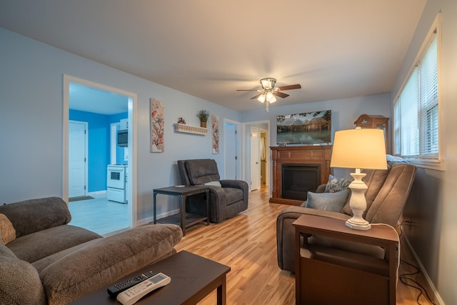 502 N Main St, Loretto, TN 38469 - living area featuring a ceiling fan, light wood finished floors, and a fireplace