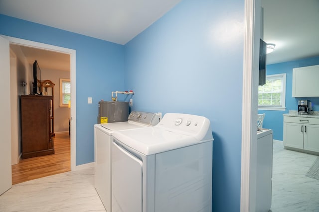 502 N Main St, Loretto, TN 38469 - laundry area featuring washing machine and dryer, water heater, and light wood-type flooring