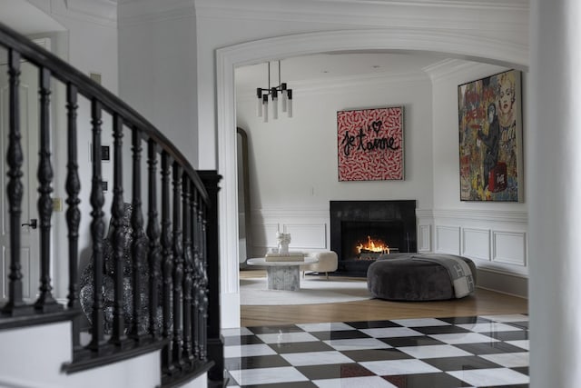 2410 Hidden River Ln, Franklin, TN 37069 - stairs with arched walkways, a warm lit fireplace, and ornamental molding