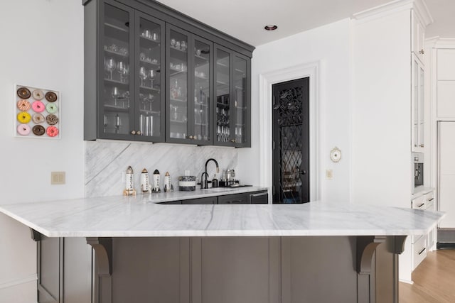 2410 Hidden River Ln, Franklin, TN 37069 - indoor wet bar with backsplash and light wood-style flooring