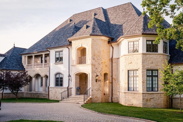 2410 Hidden River Ln, Franklin, TN 37069 - french country inspired facade featuring a balcony, stone siding, stucco siding, and a high end roof