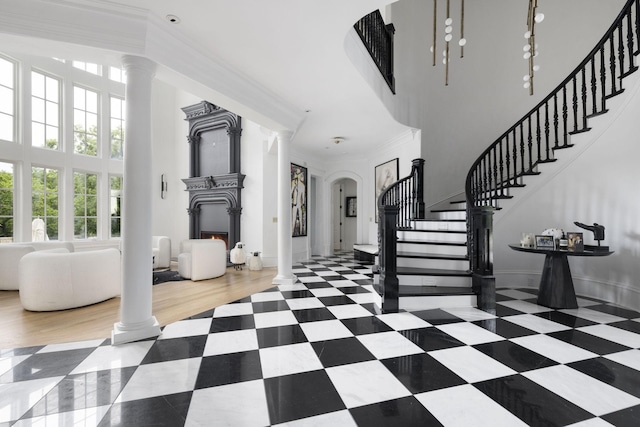 2410 Hidden River Ln, Franklin, TN 37069 - foyer featuring ornate columns, stairway, a towering ceiling, ornamental molding, and arched walkways