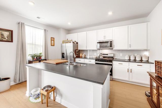 127 Millbrook Dr, Spring Hill, TN 37174 - kitchen featuring stainless steel appliances, dark countertops, decorative backsplash, light wood-style floors, and recessed lighting