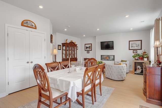 127 Millbrook Dr, Spring Hill, TN 37174 - dining room featuring light wood-style flooring, recessed lighting, and a glass covered fireplace