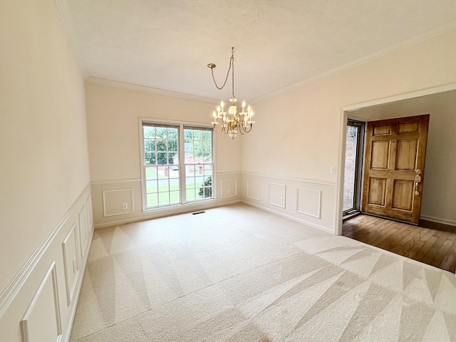 416 Barnes Dr, Lebanon, TN 37087 - carpeted spare room with ornamental molding, a chandelier, a decorative wall, and wainscoting
