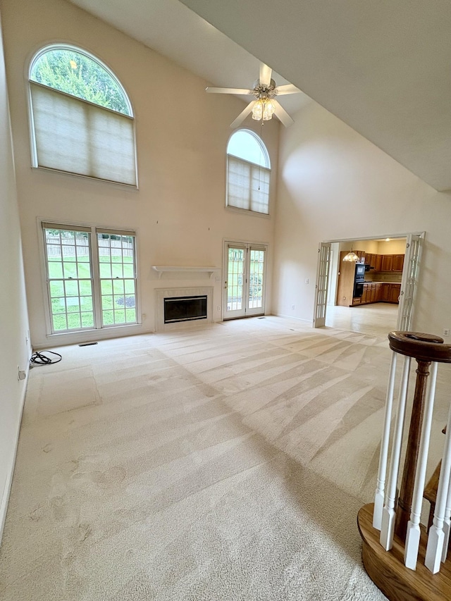 416 Barnes Dr, Lebanon, TN 37087 - unfurnished living room featuring a high ceiling, carpet floors, a ceiling fan, plenty of natural light, and a glass covered fireplace