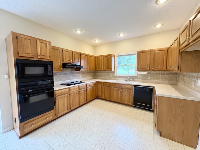 416 Barnes Dr, Lebanon, TN 37087 - kitchen featuring black appliances, under cabinet range hood, light countertops, decorative backsplash, and recessed lighting
