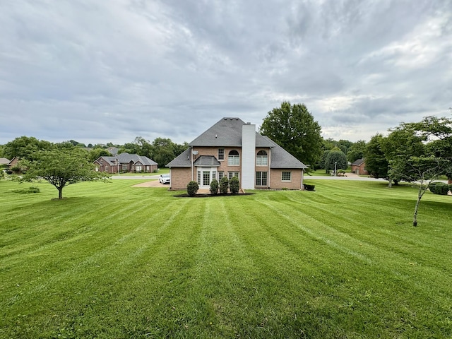 416 Barnes Dr, Lebanon, TN 37087 - back of property with a yard, a chimney, and brick siding