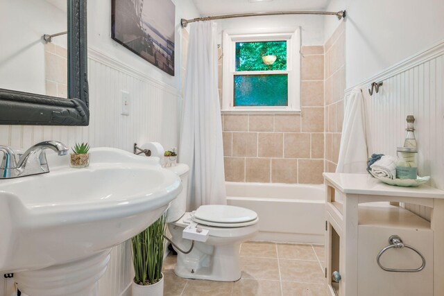 301 Panamint Dr, Antioch, TN 37013 - bathroom featuring shower / bath combo with shower curtain, tile patterned flooring, and wainscoting