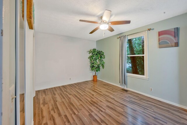 301 Panamint Dr, Antioch, TN 37013 - empty room with wood finished floors, ceiling fan, and a textured ceiling