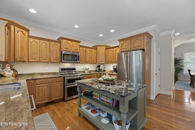 48 Riverside Dr, Oak Ridge, TN 37830 - kitchen with stainless steel appliances, open shelves, arched walkways, dark stone countertops, and light wood-style floors