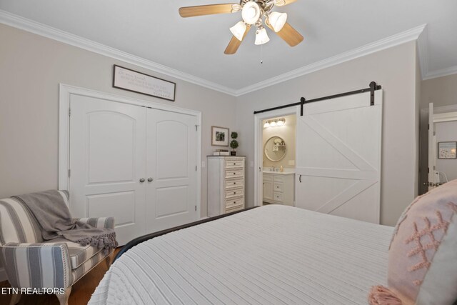 48 Riverside Dr, Oak Ridge, TN 37830 - bedroom with ornamental molding, a barn door, a closet, wood finished floors, and ceiling fan