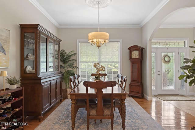 48 Riverside Dr, Oak Ridge, TN 37830 - dining space featuring arched walkways, dark wood finished floors, and ornamental molding