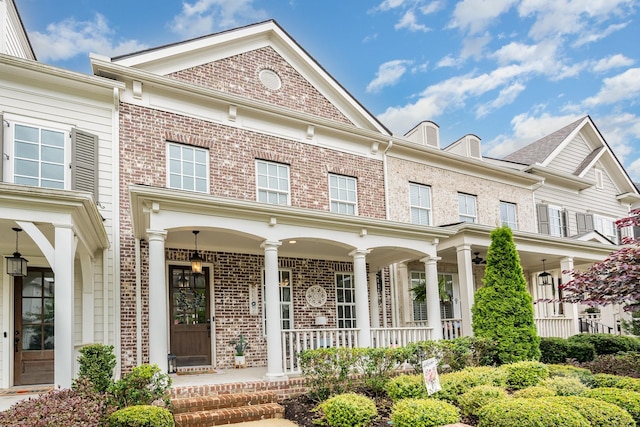 1055 Beckwith St, Franklin, TN 37064 - view of front facade featuring covered porch and brick siding