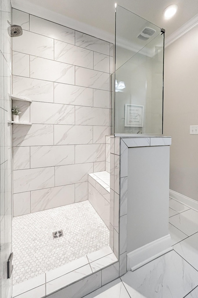 1055 Beckwith St, Franklin, TN 37064 - bathroom with ornamental molding, marble look tiles, and a walk in shower