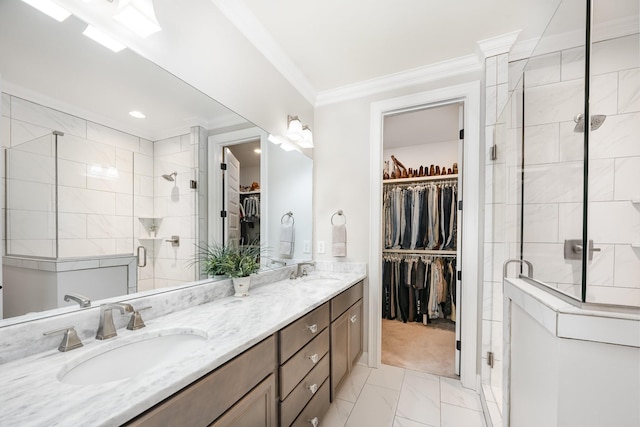 1055 Beckwith St, Franklin, TN 37064 - bathroom featuring a spacious closet, double vanity, ornamental molding, a shower stall, and marble finish flooring