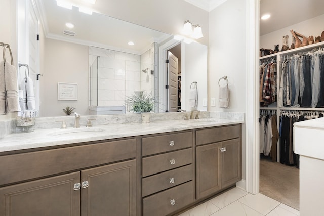 1055 Beckwith St, Franklin, TN 37064 - full bathroom featuring ornamental molding, double vanity, a spacious closet, a tile shower, and marble look tiles