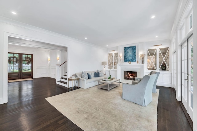 1932 Rosewood Valley Dr, Brentwood, TN 37027 - living area featuring french doors, a decorative wall, a warm lit fireplace, stairway, and dark wood-type flooring