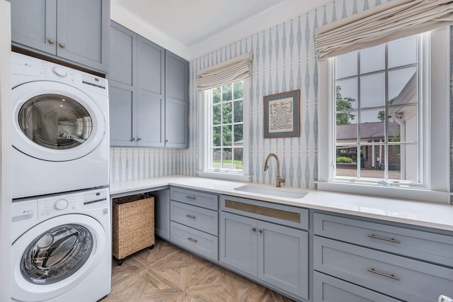 1932 Rosewood Valley Dr, Brentwood, TN 37027 - laundry room featuring cabinet space, wallpapered walls, and stacked washing machine and dryer
