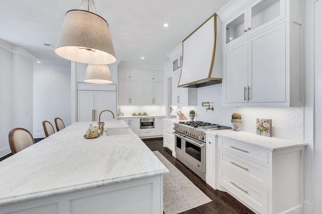 1932 Rosewood Valley Dr, Brentwood, TN 37027 - kitchen featuring high quality appliances, a kitchen island with sink, recessed lighting, dark wood-style flooring, and white cabinets