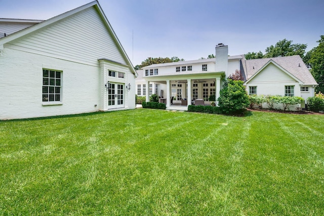 1932 Rosewood Valley Dr, Brentwood, TN 37027 - rear view of house featuring french doors, a lawn, an outdoor living space, and a ceiling fan