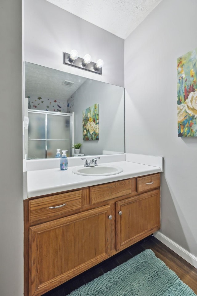 113 Beck Ct, Murfreesboro, TN 37128 - bathroom with vanity, a shower stall, wood finished floors, and a textured ceiling