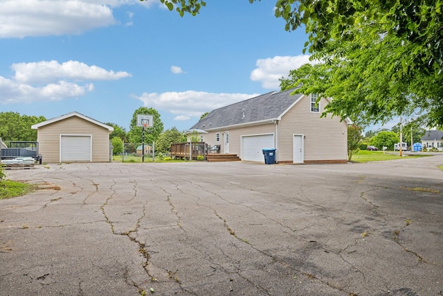 113 Beck Ct, Murfreesboro, TN 37128 - view of side of property featuring an outdoor structure, a deck, roof with shingles, and a garage