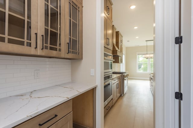 5959 Hunt Valley Dr, Spring Hill, TN 37174 - kitchen featuring glass insert cabinets, light wood-style flooring, backsplash, light stone countertops, and recessed lighting