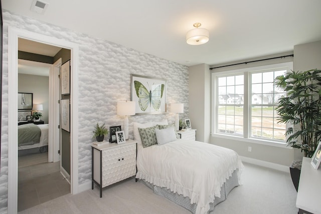 5969 Hunt Valley Dr, Spring Hill, TN 37174 - bedroom with an accent wall, wallpapered walls, and light carpet