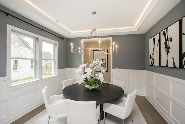 5969 Hunt Valley Dr, Spring Hill, TN 37174 - dining room with dark wood-type flooring, a chandelier, a decorative wall, a tray ceiling, and a wainscoted wall