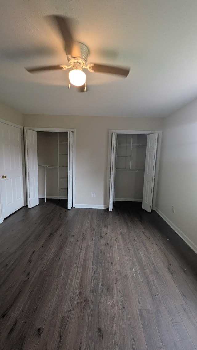 106 Beech Forge Dr, Antioch, TN 37013 - unfurnished bedroom with dark wood-style floors, two closets, and ceiling fan