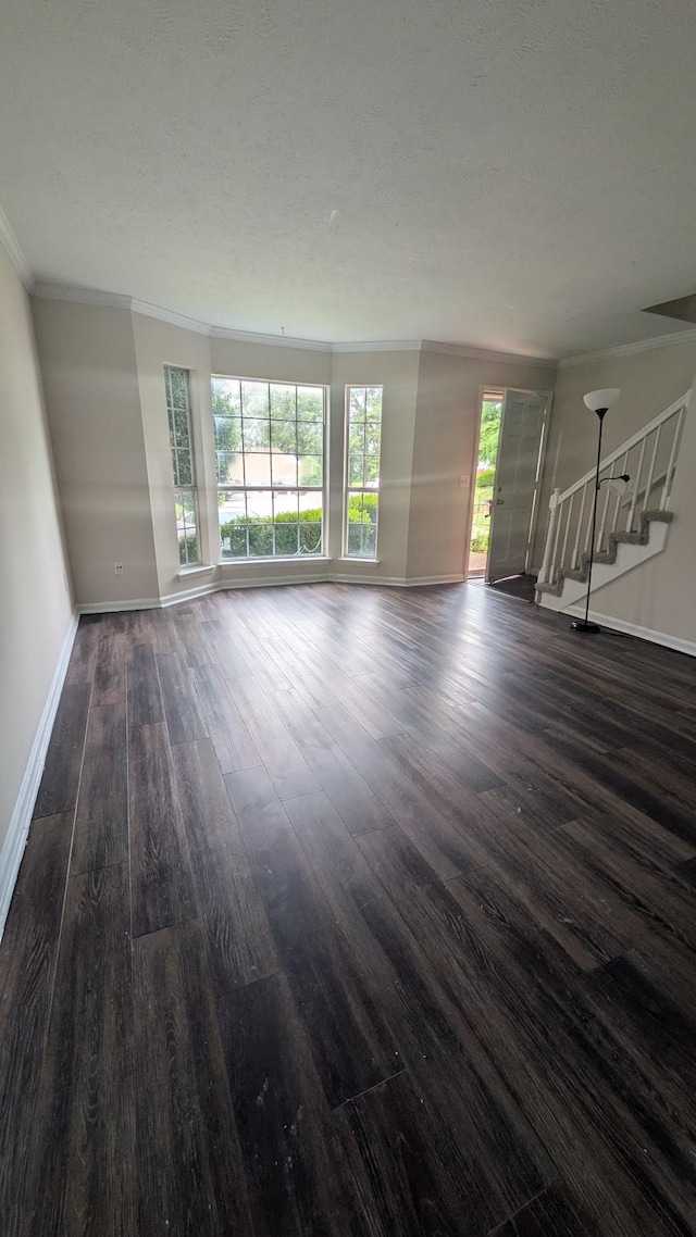 106 Beech Forge Dr, Antioch, TN 37013 - unfurnished living room with dark wood-style flooring, ornamental molding, and stairway