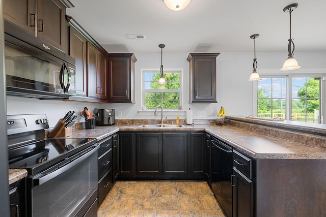 3228 Marion Davis Dr, Murfreesboro, TN 37129 - kitchen with black appliances, a peninsula, dark brown cabinets, light stone finish flooring, and pendant lighting
