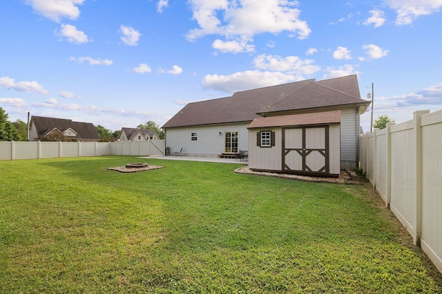 3228 Marion Davis Dr, Murfreesboro, TN 37129 - back of property with an outdoor fire pit, a patio, a storage unit, a fenced backyard, and roof with shingles