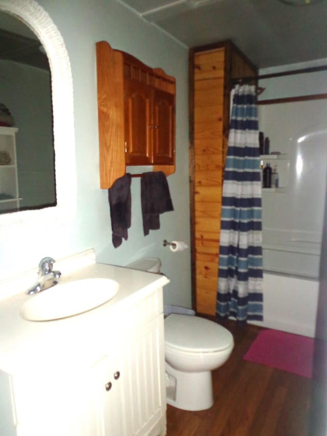 1342 Russell Creek Rd, Lobelville, TN 37097 - bathroom with vanity, wood finished floors, and shower / bath combo with shower curtain