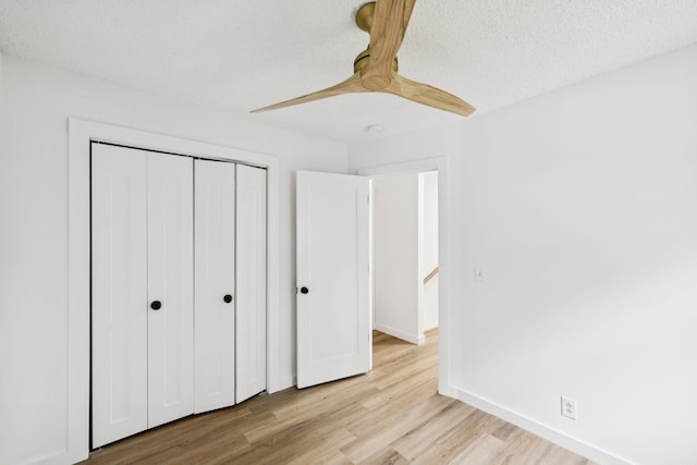 3345 Towneship Rd, Antioch, TN 37013 - unfurnished bedroom with light wood-style flooring, a closet, ceiling fan, and a textured ceiling