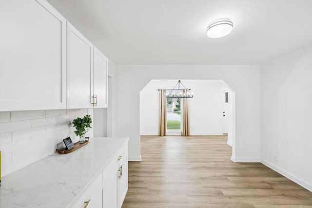 3345 Towneship Rd, Antioch, TN 37013 - hall with a chandelier, arched walkways, and light wood-style floors