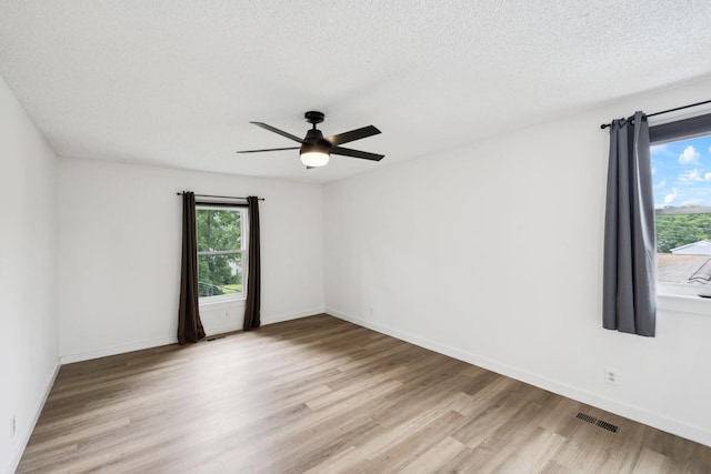 3345 Towneship Rd, Antioch, TN 37013 - empty room featuring healthy amount of natural light, light wood-style floors, ceiling fan, and a textured ceiling