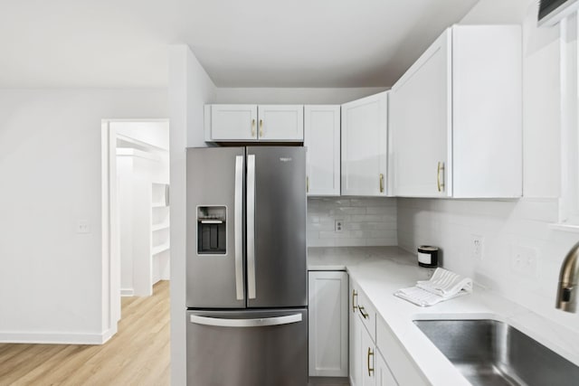 3345 Towneship Rd, Antioch, TN 37013 - kitchen with stainless steel fridge with ice dispenser, light wood-style flooring, decorative backsplash, and white cabinetry