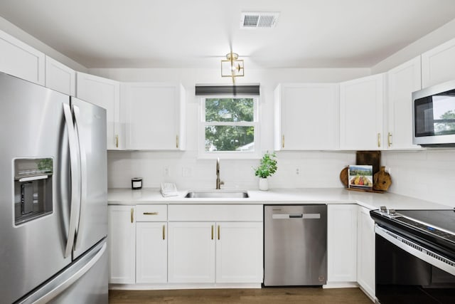 3345 Towneship Rd, Antioch, TN 37013 - kitchen featuring appliances with stainless steel finishes, white cabinets, backsplash, and light countertops