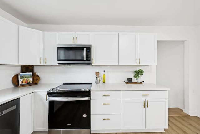 3345 Towneship Rd, Antioch, TN 37013 - kitchen featuring stainless steel appliances, white cabinetry, light countertops, and decorative backsplash