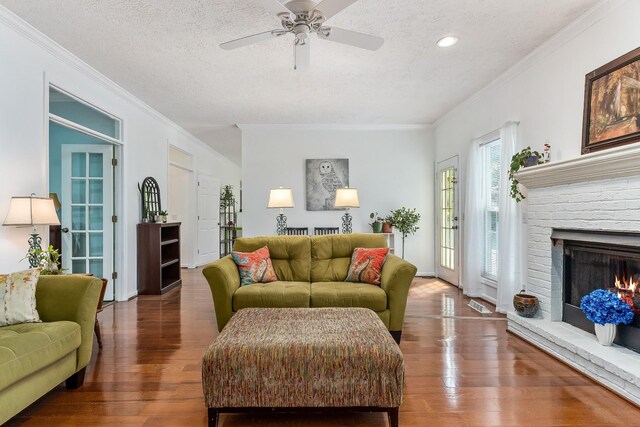 237 Windsor Dr, Cookeville, TN 38506 - living room with a textured ceiling, hardwood / wood-style flooring, crown molding, a fireplace, and a ceiling fan