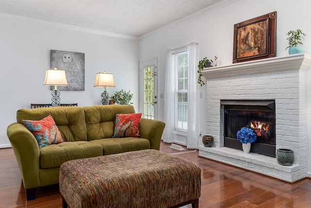 237 Windsor Dr, Cookeville, TN 38506 - living room with wood finished floors, a brick fireplace, a textured ceiling, and crown molding
