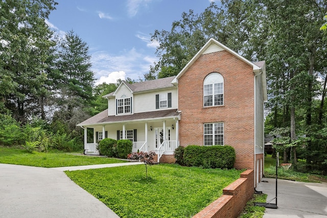 237 Windsor Dr, Cookeville, TN 38506 - traditional home with covered porch, a front yard, and brick siding