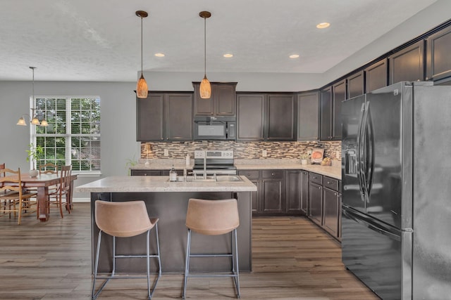 147 N Shadowhaven Way, Hendersonville, TN 37075 - kitchen featuring fridge with ice dispenser, black microwave, wood finished floors, backsplash, and recessed lighting