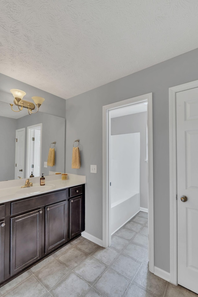 147 N Shadowhaven Way, Hendersonville, TN 37075 - full bathroom with vanity, a textured ceiling, a tub, and a chandelier